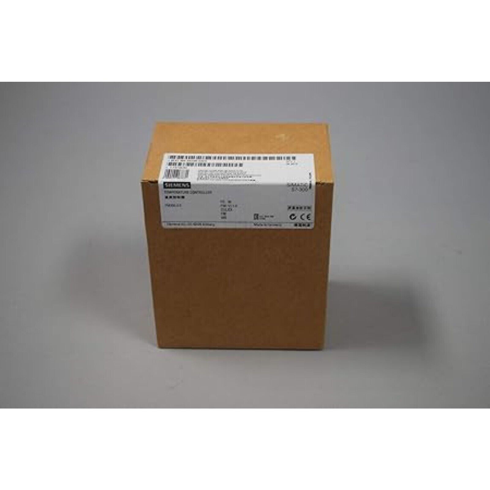 Siemens Simatic S7-300 temperature controller module in its original cardboard packaging, industrial automation part.