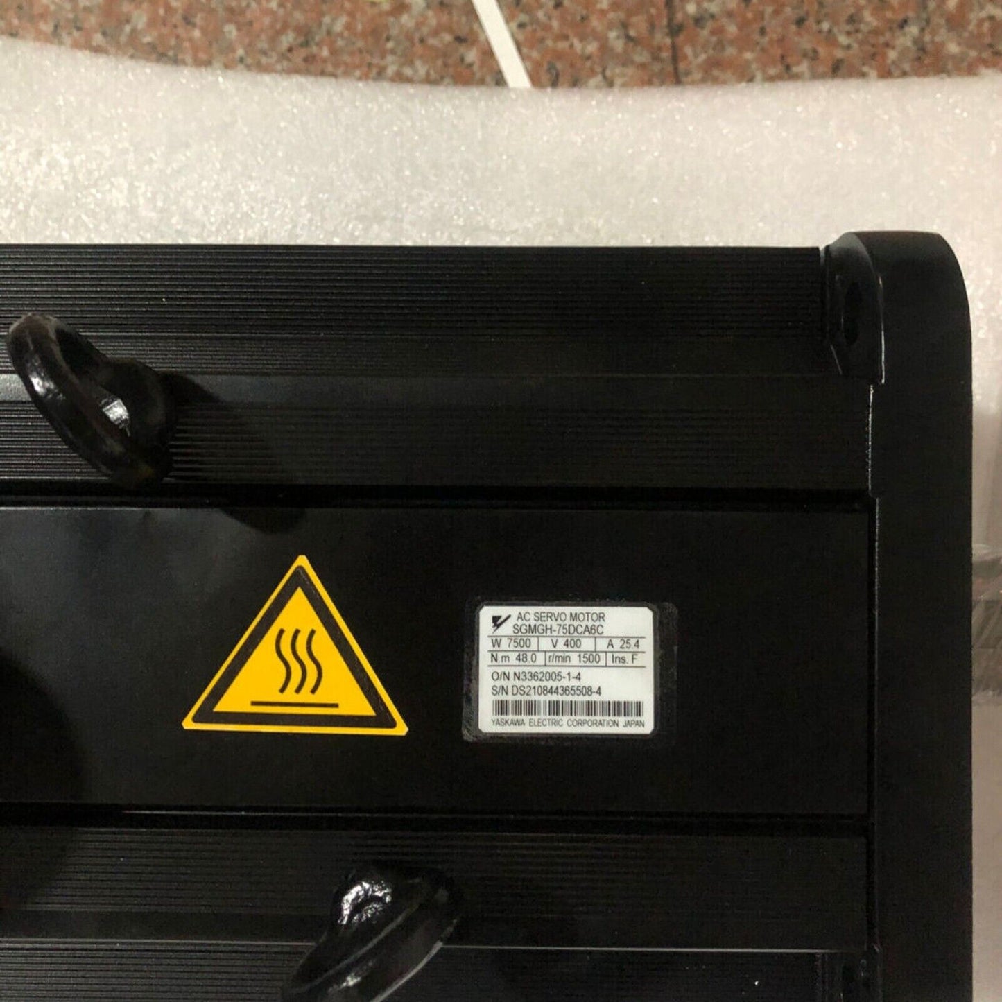 Yaskawa SGMGH-75DCA6C AC servo motor, black industrial equipment, heat warning label, 7500W, 400V, 25.4A.