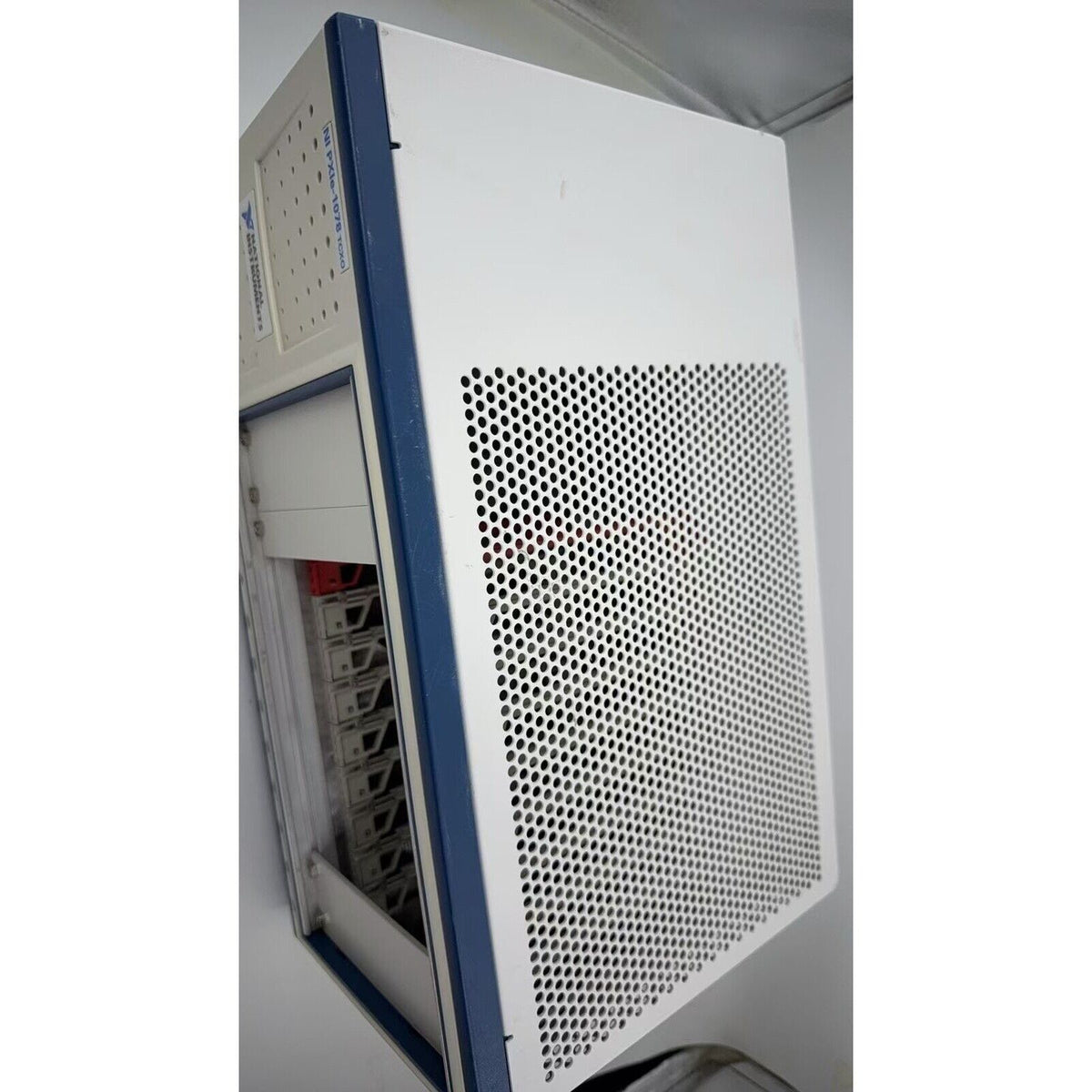 National Instruments PXIe-1078 TCXO PXI Chassis, white and blue industrial automation equipment. NI PXI Express Mainframe.