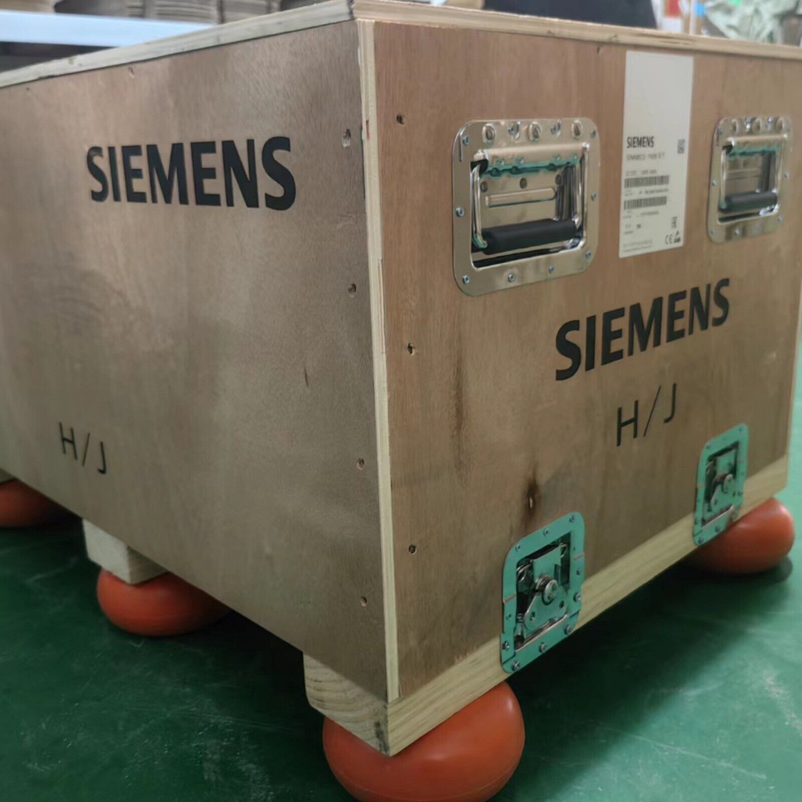 Siemens industrial automation component shipping crate, wooden box with metal hardware, H/J marking, orange supports