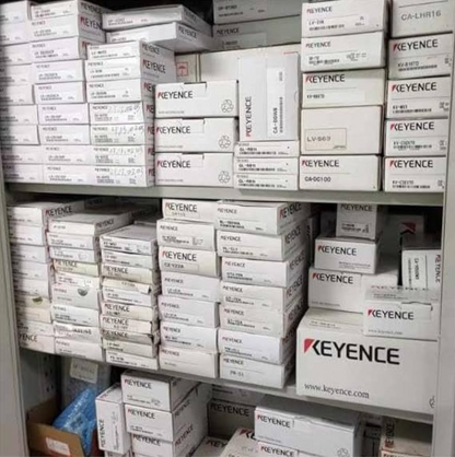 Keyence industrial automation parts stock. Boxes of sensors, including models like CA-DGW5 and LV-S63, ready for shipping.