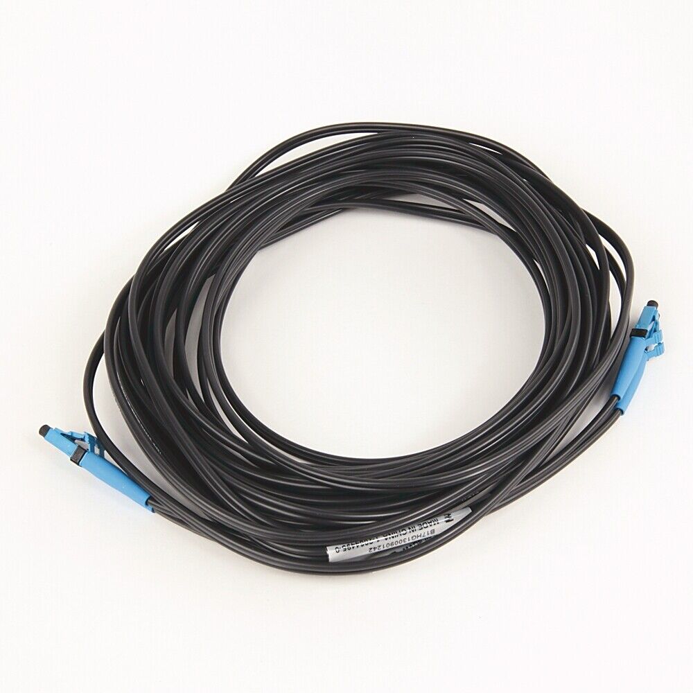 Black fiber optic cable with blue connectors, coiled on white background.