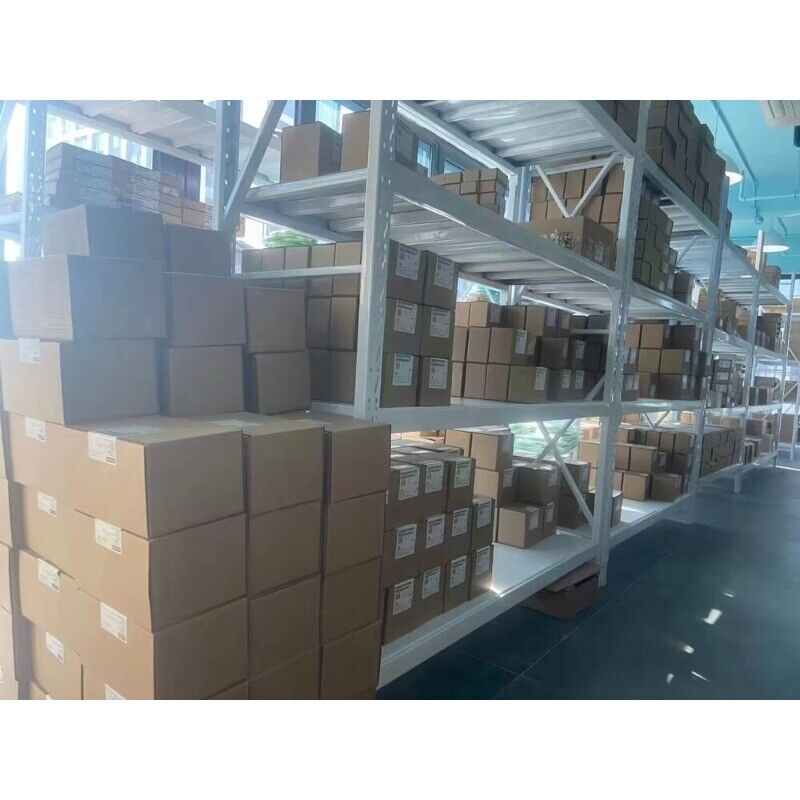 Warehouse with PLC and industrial automation parts in boxes, including FANUC IC200ALG240-JE modules.