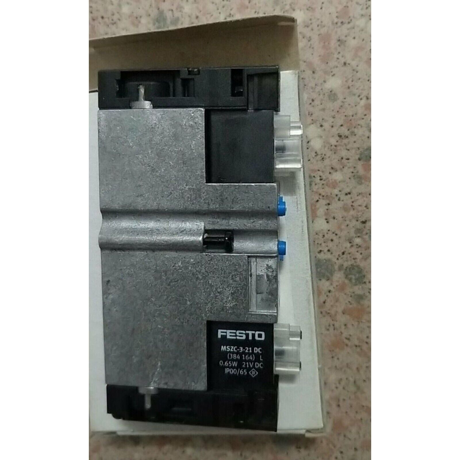 Festo MSZC-3-21 DC solenoid valve component. Industrial automation equipment with blue accents and product details.