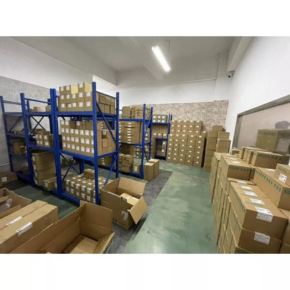 Warehouse stock of industrial automation parts, including Allen-Bradley controllers, on blue shelving, Radwell International.