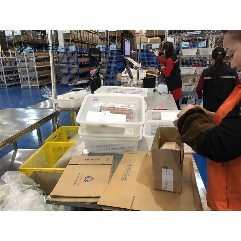 Warehouse stock and shipping Allen-Bradley PLC parts. Staff preparing orders for shipment, focus on product packaging.