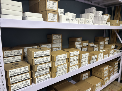 Allen-Bradley industrial automation parts, boxes on shelves in warehouse.