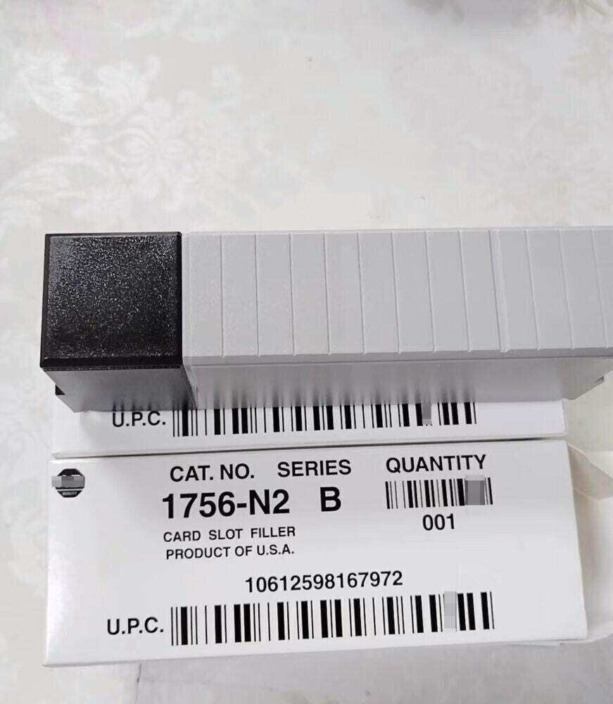 Allen-Bradley 1756-N2 Card Slot Filler, light gray plastic, with product information on the box, for ControlLogix chassis.