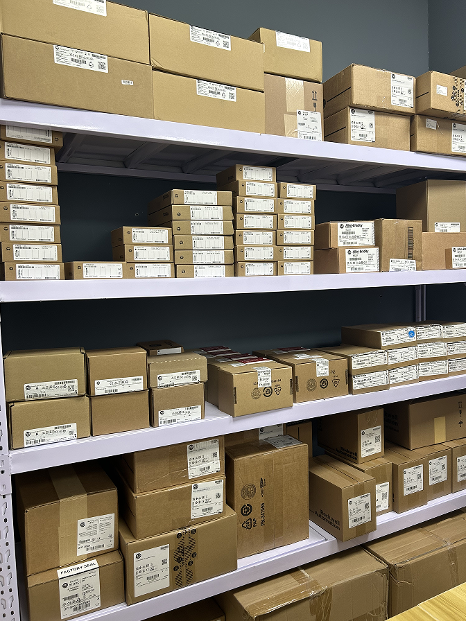 Allen-Bradley Compact GuardLogix 5380 controllers in boxes on shelves, warehouse storage.