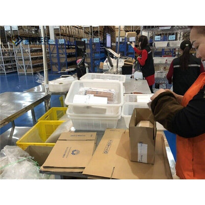 Warehouse staff packing and preparing Allen-Bradley 1762-OW8 MicroLogix modules for shipment.