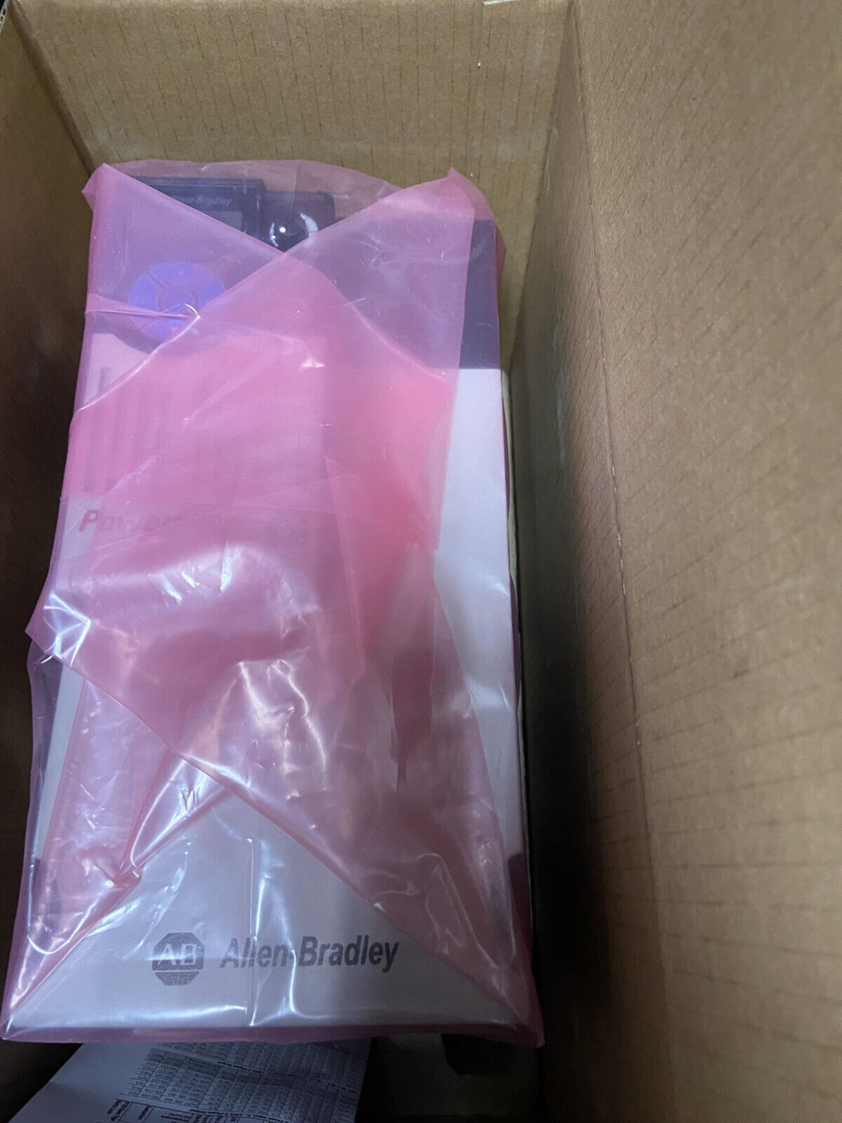 Allen-Bradley PowerFlex 525 AC Drive in box, with protective pink plastic wrap.