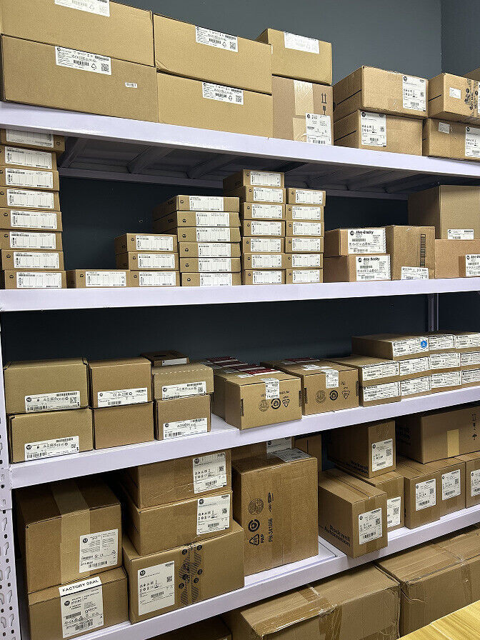 Allen-Bradley PLC inventory, boxes on shelves, industrial automation components, ready for shipping.