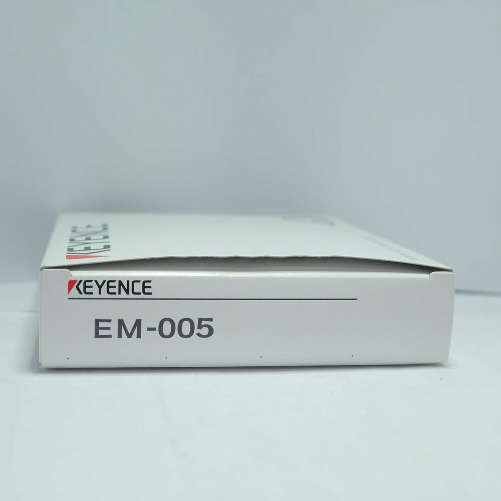 Keyence EM-005 sensor box. Industrial automation part packaging.