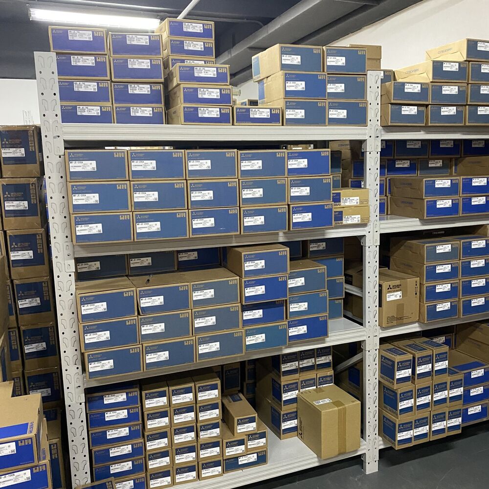 Mitsubishi MR-J3-350B servo drive boxes on warehouse shelves, new in box, industrial automation parts.
