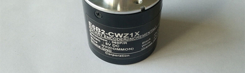 Omron E6B2-CWZ1X rotary encoder, 360P/R resolution, 5V DC, black cylinder with white text. Industrial automation part.