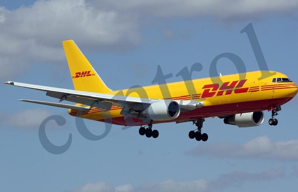 DHL cargo plane in flight, yellow and red livery, transporting industrial automation parts.