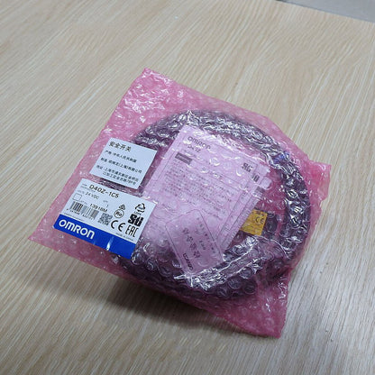 New OMRON D40Z-1C5 Door Switch 24VDC in pink protective packaging. Industrial automation sensor part.