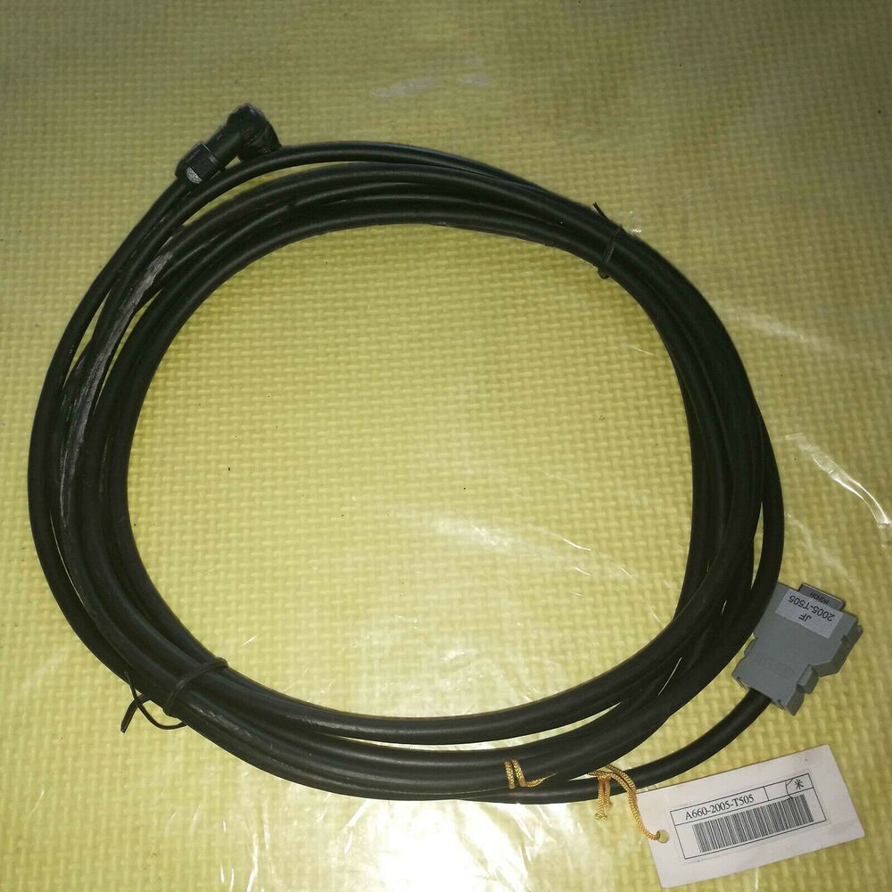 FANUC A660-2005-T505 5m Servo Motor Encoding Cable, black, coiled on yellow surface, with connector and product label.