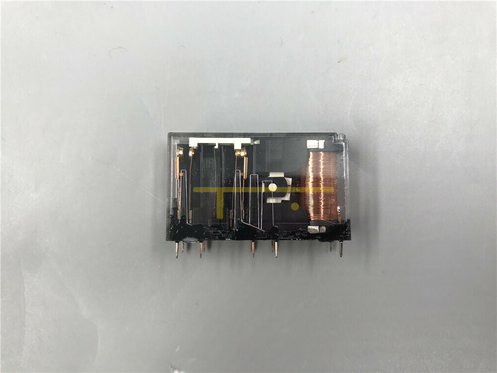Omron G7SA-2A2B safety relay with clear plastic housing, black base, and copper coil. Industrial automation component.