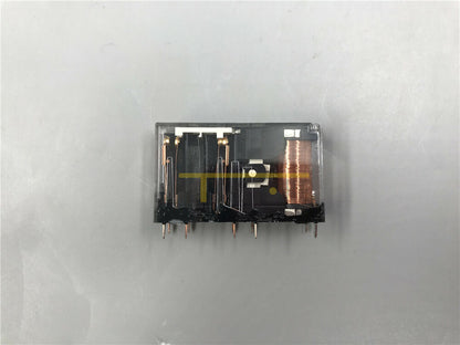 Omron G7SA-2A2B safety relay with clear plastic housing, black base, and copper coil. Industrial automation component.