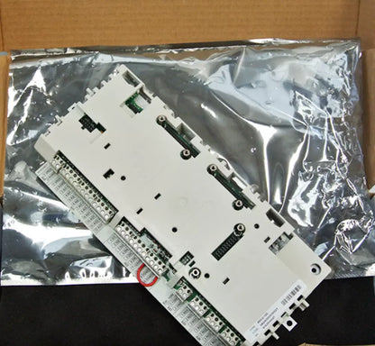 ABB RDCU-12C IO Control Board. White circuit board with connectors, industrial automation part, in box.