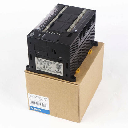 Omron CP1L-M40DT1-D PLC controller, black with terminal blocks, on cardboard box. Industrial automation equipment.