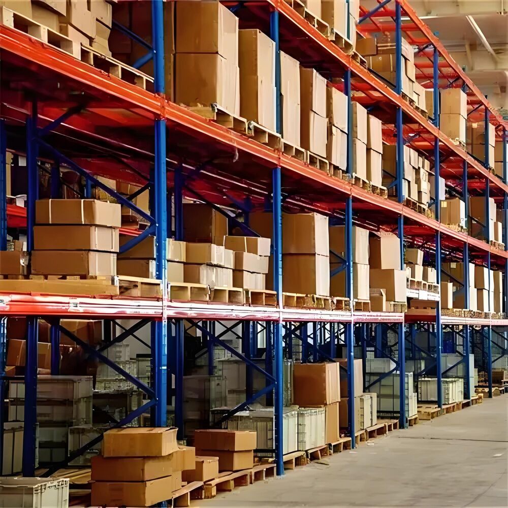 Warehouse with industrial automation parts, organized on red and blue shelves, ready for shipping.