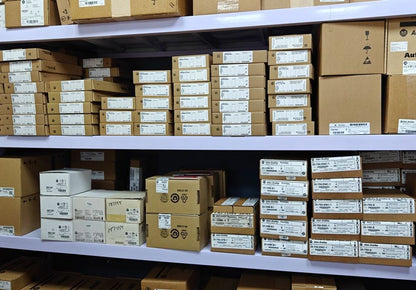Industrial automation parts inventory on shelves, featuring Allen-Bradley product boxes.