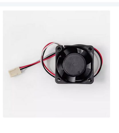 FANUC A90L-0001-0510 24V cooling fan. Black fan blades, black frame, with red, black, and white wires for PLC.