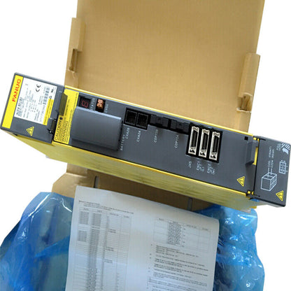 FANUC A06B-6114-H210 Servo Driver, yellow and gray industrial automation component with warning label in box.