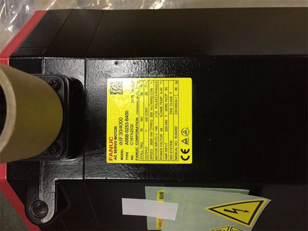 FANUC A06B-0253-B400 servo motor, black and red casing, with product label, PLC module