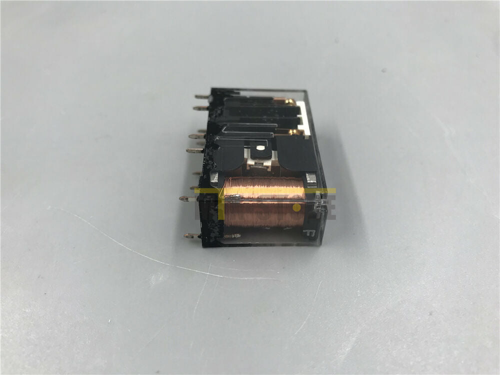 Omron G7SA-2A2B safety relay. Clear plastic housing, black components, copper coil, industrial automation component.