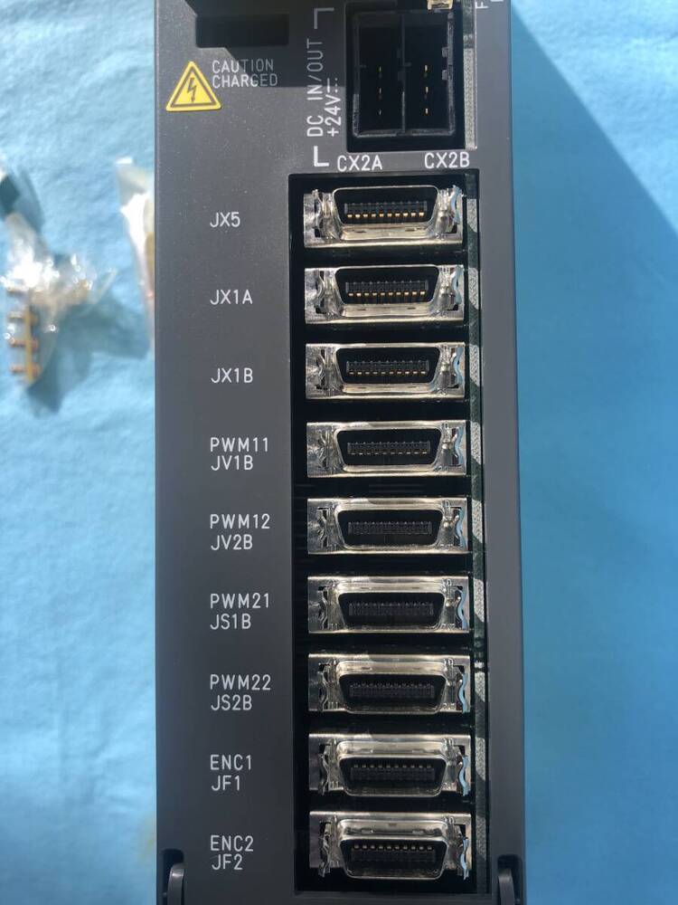 FANUC A06B-6079-H203 Servo Drive Amplifier, detail of connectors and labels. Caution Charged, DC IN/OUT +24V