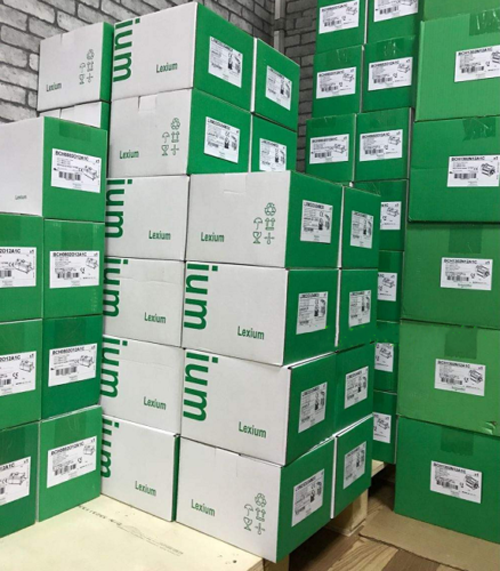 Stacked boxes of Lexium industrial automation equipment, ready for shipment. Featuring Schneider Electric products.