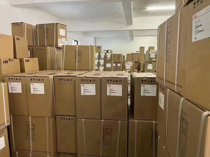 Stacked ABB boxes ready for shipping, featuring ABB logos, indicating PLC control panel products, ready for UPS shipping.