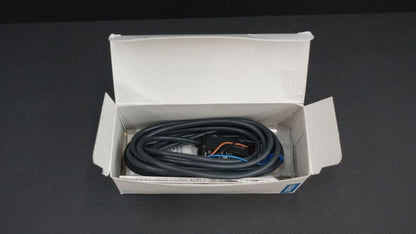 Omron E3S-AD31 photoelectric sensor in box, black cable and connector. Industrial automation part.
