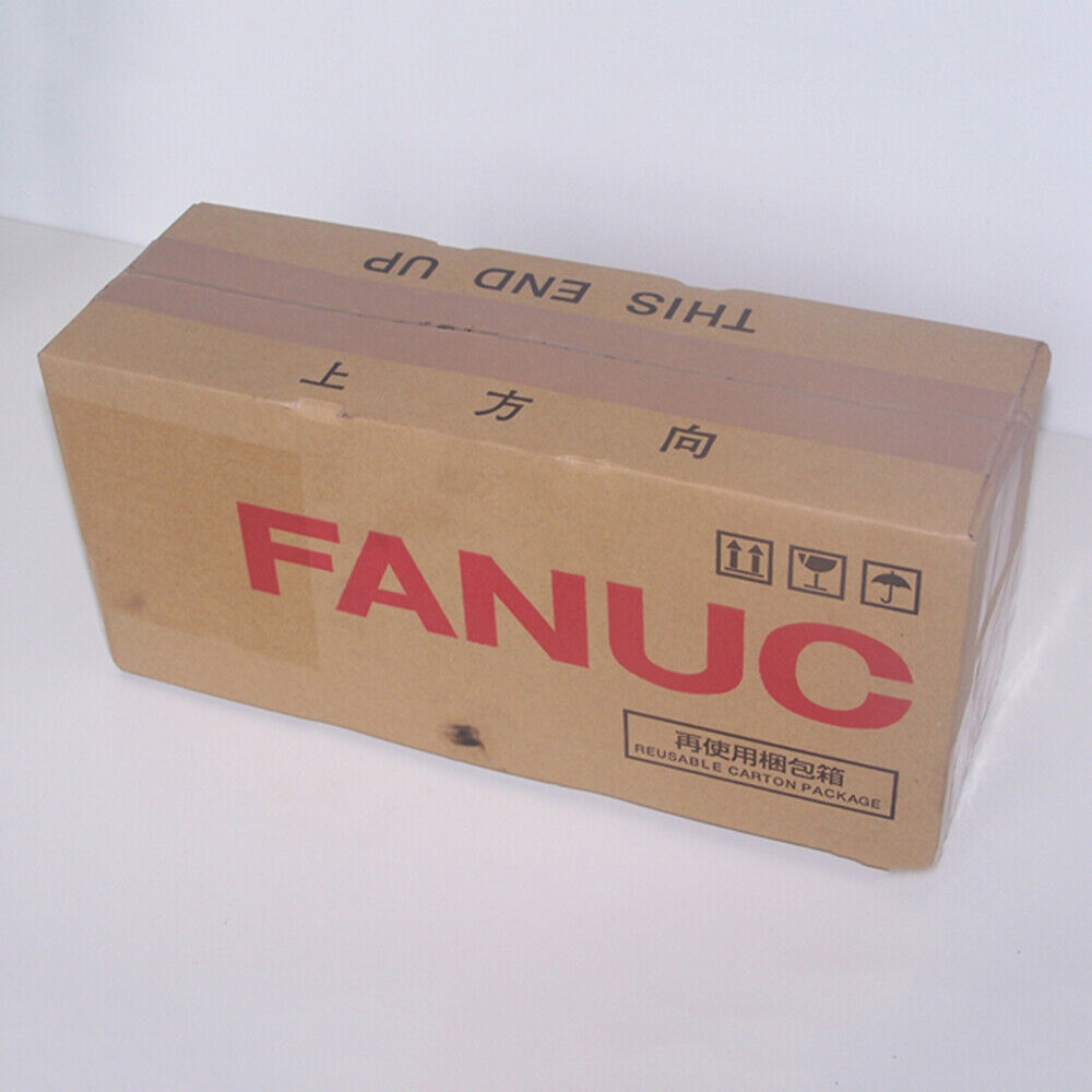 FANUC Servo Motor shipping box, brown cardboard with 'THIS END UP' and 'FANUC' text, reusable carton package