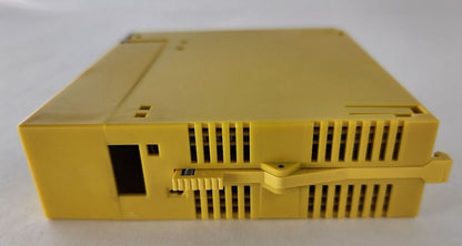 FANUC A03B-0807-C105 I/O Interface Module AID32E1, Yellow industrial PLC module, side view.