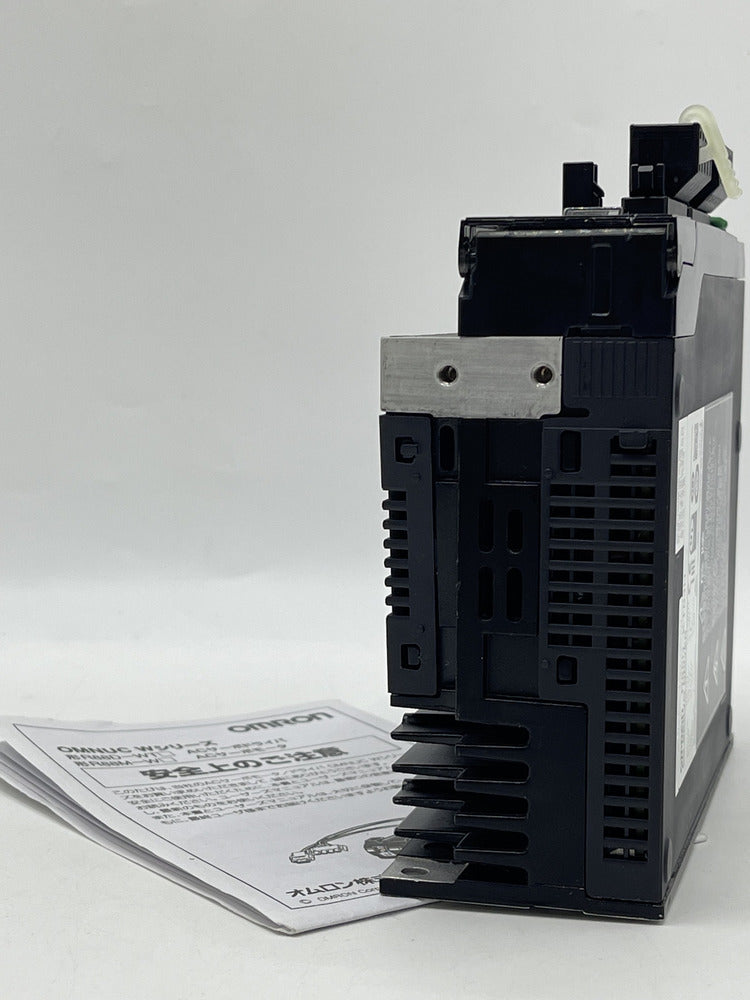 Omron R88D-KT04H AC Servo Drive side view with documentation, new industrial automation component.