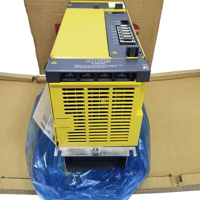 FANUC A06B-6141-H037#H580 Servo Drive in box, yellow and gray industrial automation part. Warning label visible.