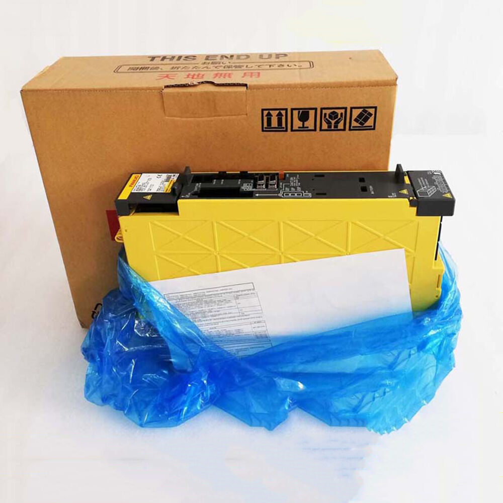 FANUC A06B-6117-H106 Servo Drive, yellow component, new in box with "THIS END UP" label.