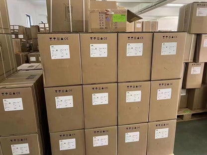 Stacked ABB PLC control panel boxes ready for UPS shipping, new in box, featuring ABB logos and labels.