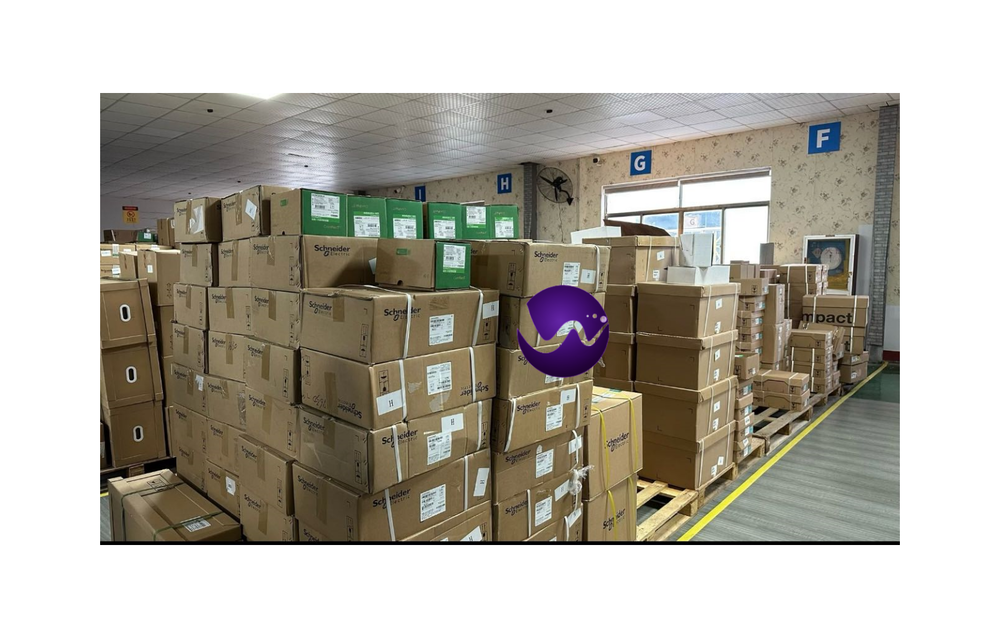 Warehouse stock of Schneider Electric products on pallets, industrial automation parts.