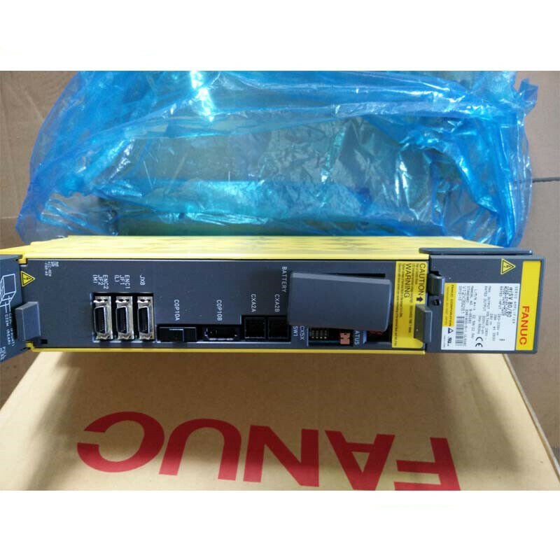 FANUC A06B-6240-H209 Servo Drive, yellow and gray industrial automation component. Warning label and multiple ports.