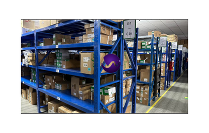 Industrial automation parts warehouse with ABB frequency converters on blue shelves, organized stock.