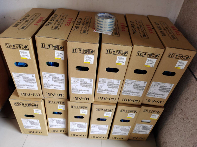 FANUC A06B-6141-H037#H580 Servo Drive boxes stacked, marked 'THIS END UP' and handling instructions, ready for fast shipping.
