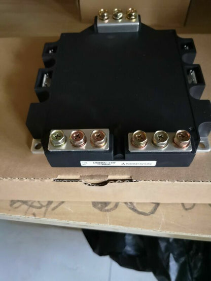 Mitsubishi CM900DU-24NF Inverter Module, black industrial automation component with multiple terminals and mounting hardware.