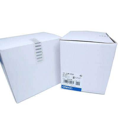 Omron CJ2M-CPU32 PLC module in box. Product information label includes CPU unit details and OMRON logo.