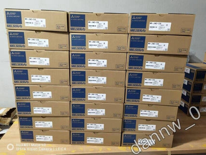 Mitsubishi MR-J4W2-22B AC Servo Drive boxes stacked in a warehouse, ready for shipping. MELSERVO.