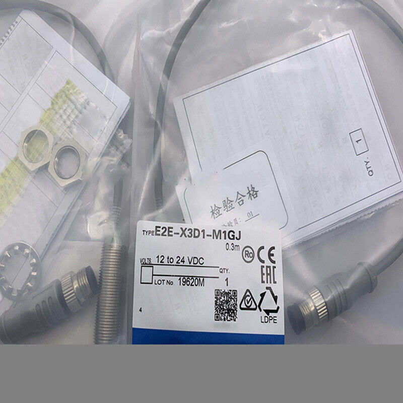 Omron E2E-X3D1-M1GJ proximity switch in packaging, 12-24VDC, with labels and CE/EAC marks, 0.3m cable.
